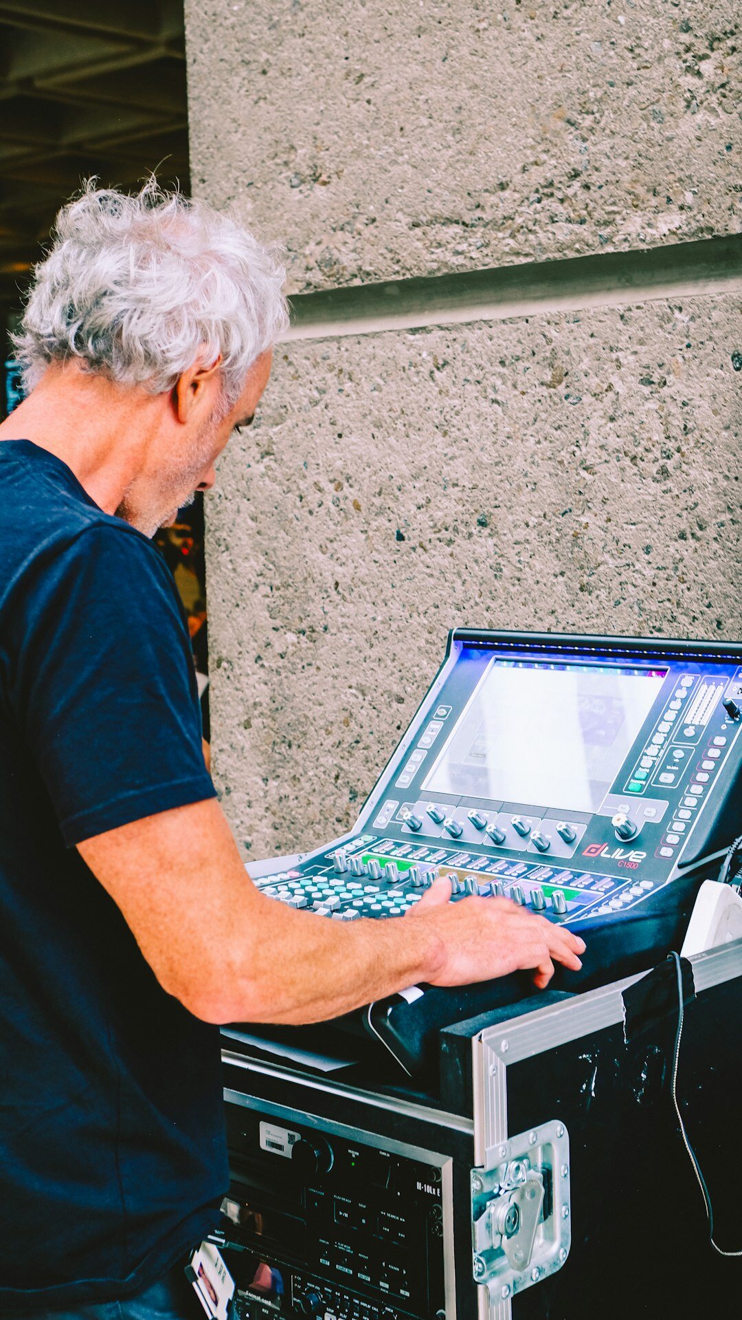 Technician preparing audio and video signals at a mixing console